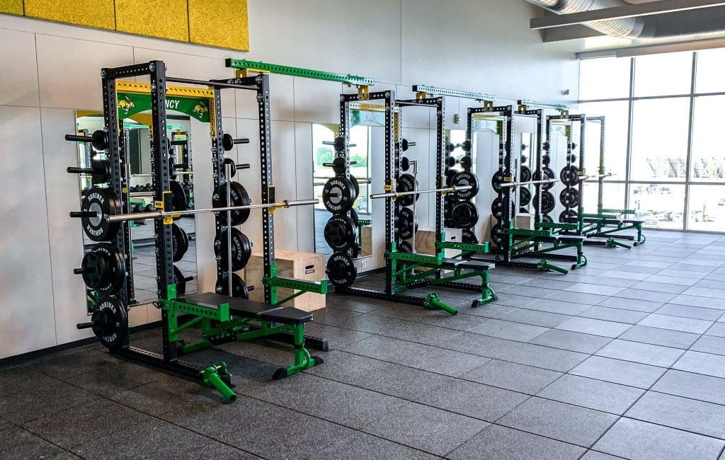 Weight room rules for high school help to keep weight rooms clean and organized like this one.