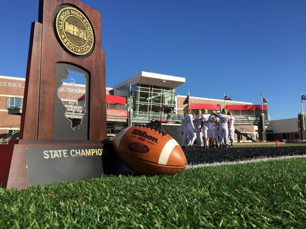 State championship trophy next to football.