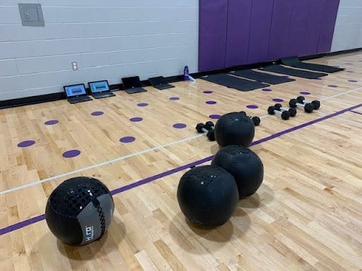 Chromebooks, medballs, and dummbells set up for PE class at Lewiston High School.