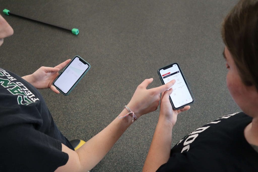 Students use the PLT4M app during a fitness lesson in PE class.