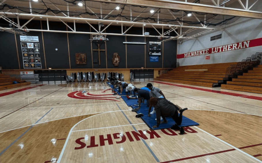 Students stretch in the gym at Milwaukee Lutheran.