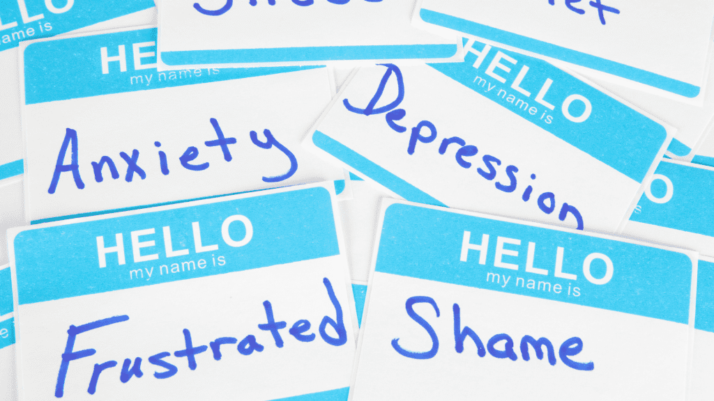 Name tags with different types of mental health issues like anxiety, depression, and shame.