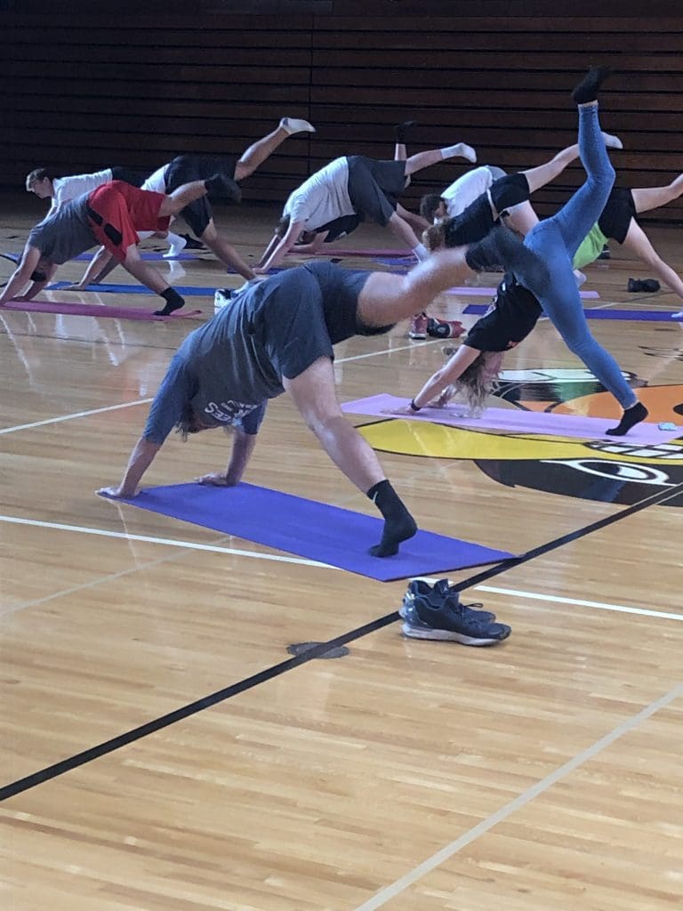 Quincy students participate in a yoga lesson during physical education class.