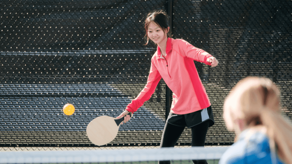 student playing pickleball