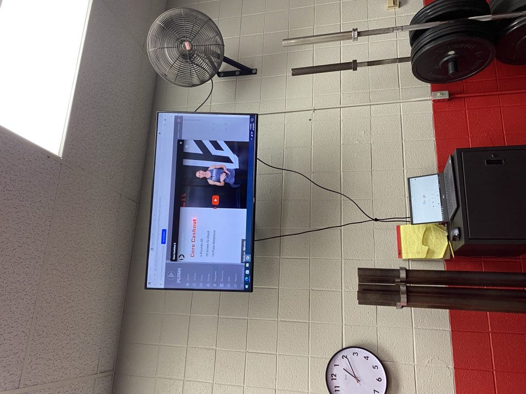 A PLT4M video displayed in the Jacksonville High School weight room.