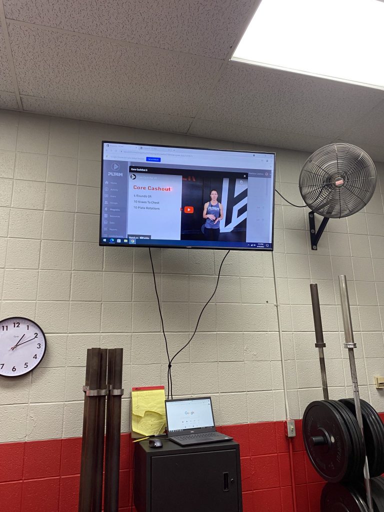 A PLT4M video displayed in the Jacksonville High School weight room.