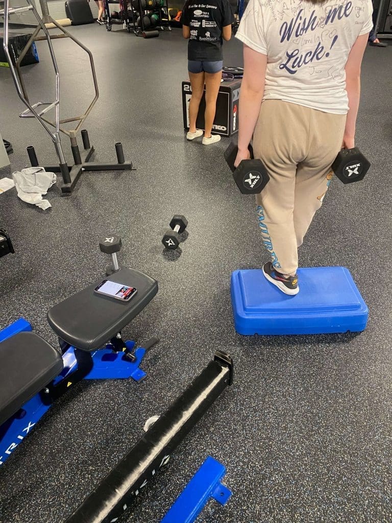 A student works out at Reedsburgh High School and has PLT4M app open.