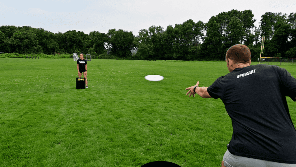 Kan Jam player throws frisbee to partner.