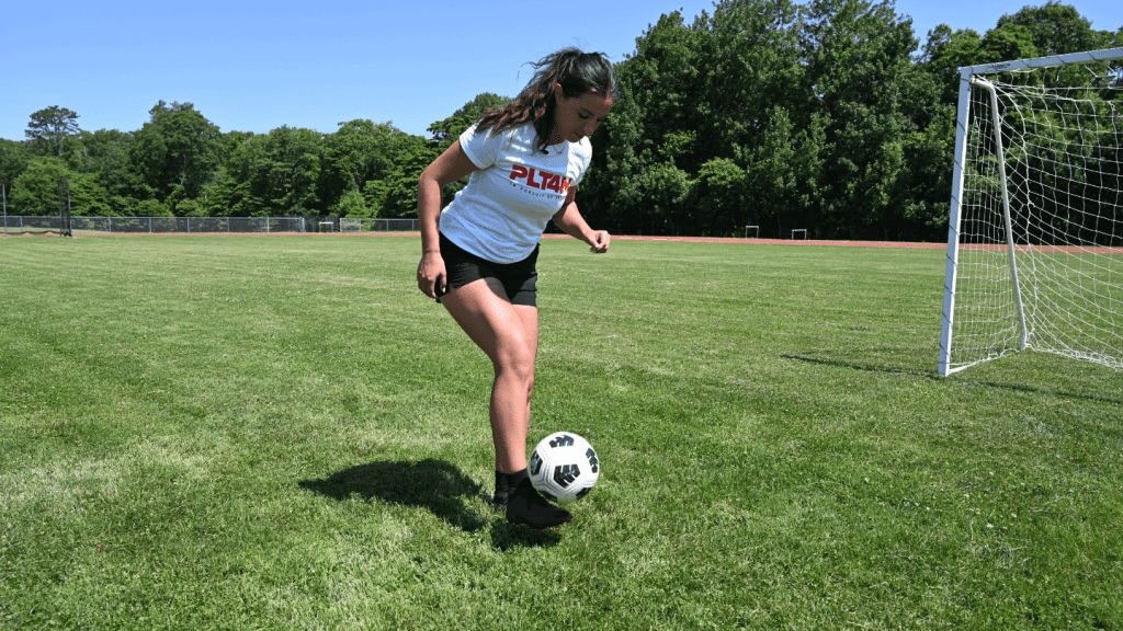 PLT4M instructor Ally Lima demonstrates juggling the soccer ball.