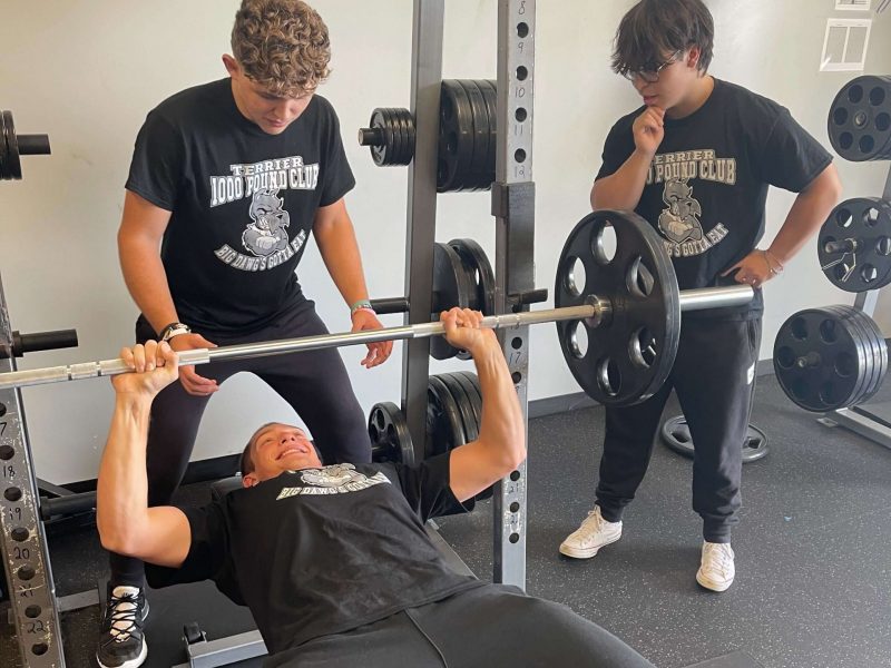 Carbondale Carbondale student performs bench press with a spotter and onlooker.